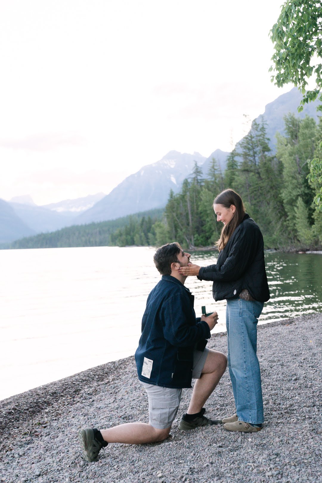 Parker proposing on the shore of Lake McDonald
